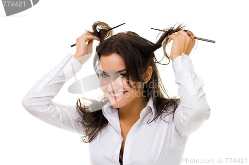 Image of woman twirl her hair with sticks