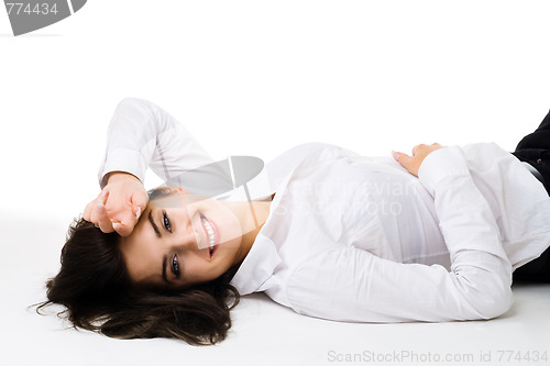 Image of Happy young woman in white clothes lay on the floor