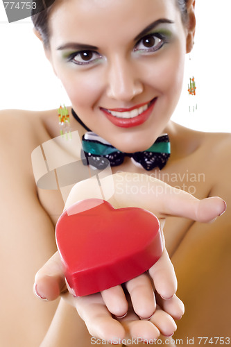 Image of Beautiful young woman holding a red heart