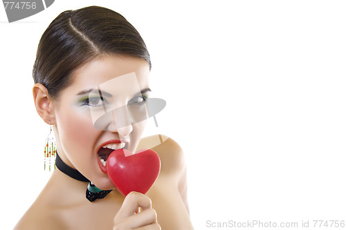 Image of attractive woman biting a red heart