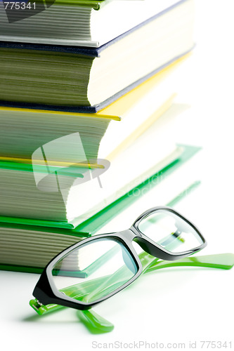 Image of stack of books and glasses