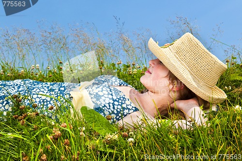 Image of Young girl resting in meadow