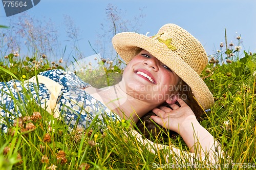 Image of Young girl laying on meadow