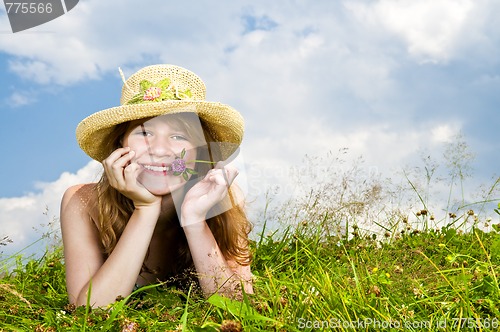 Image of Young girl laying in meadow