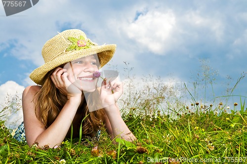 Image of Young girl laying in meadow