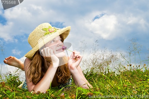 Image of Young girl laying in meadow