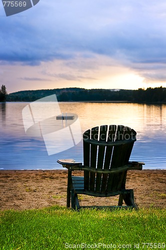 Image of Wooden chair at sunset on beach