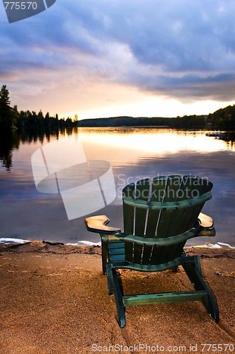 Image of Wooden chair at sunset on beach