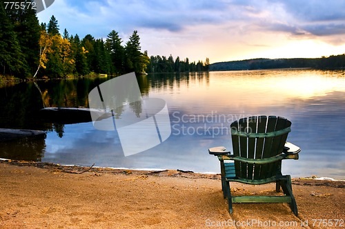 Image of Wooden chair at sunset on beach