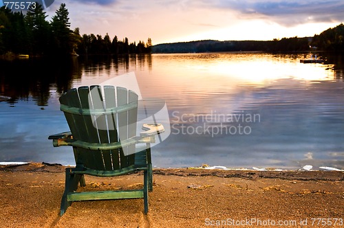 Image of Wooden chair at sunset on beach