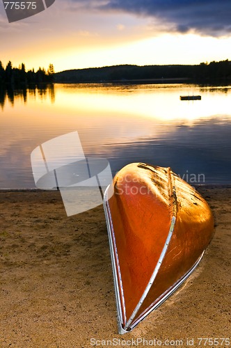 Image of Lake sunset with canoe on beach