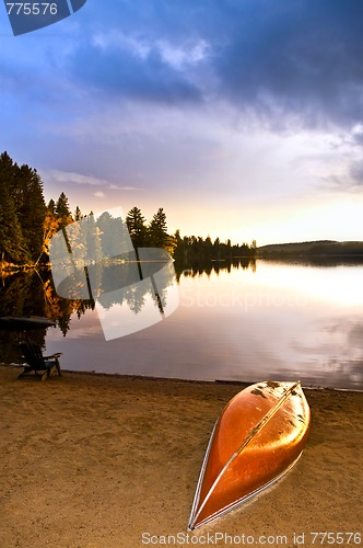 Image of Lake sunset with canoe on beach