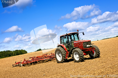 Image of Tractor in plowed field