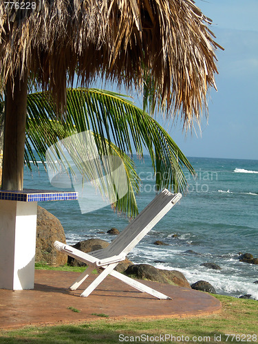 Image of chair under thatched roof hut corn island nicaragua