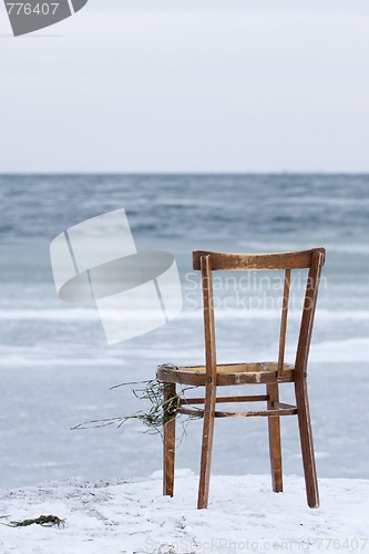 Image of Chair washed ashore and facing the ocean