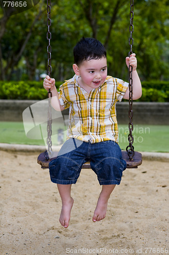 Image of cute boy on a swing