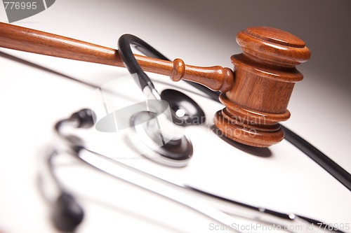 Image of Gavel and Stethoscope on Gradated Background