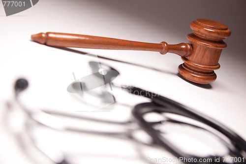 Image of Gavel and Stethoscope on Gradated Background