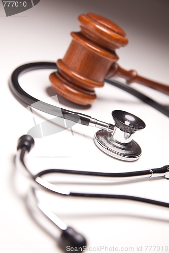 Image of Gavel and Stethoscope on Gradated Background