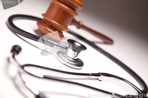 Image of Gavel and Stethoscope on Gradated Background