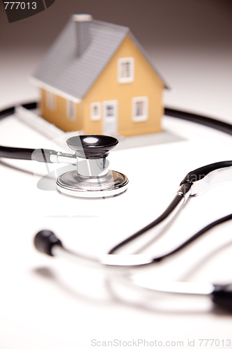 Image of Stethoscope and Model House on Gradated Background