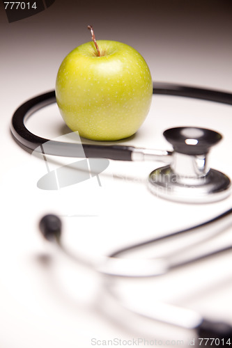 Image of Stethoscope and Green Apple on Gradated Background