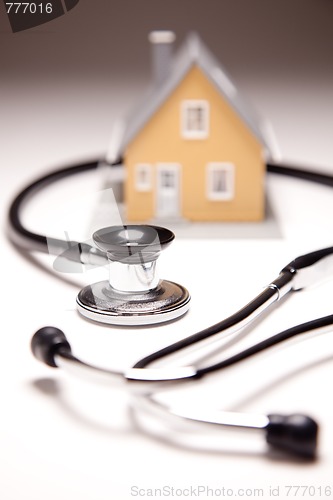 Image of Stethoscope and Model House on Gradated Background