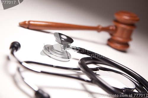 Image of Gavel and Stethoscope on Gradated Background