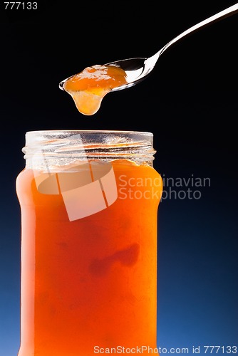 Image of apricot jam and tea spoon