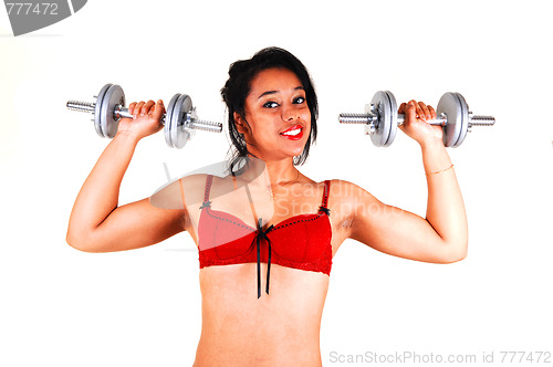 Image of Young girl lifting weight.