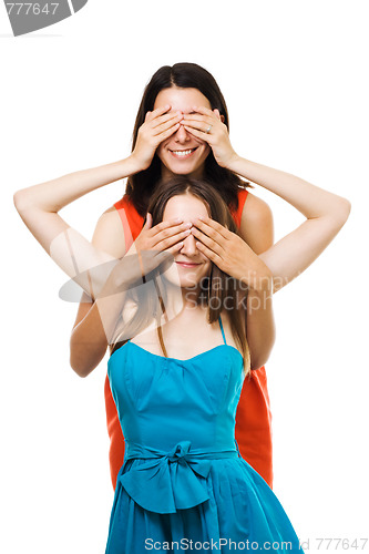 Image of Two womans play with their hands in color dresses