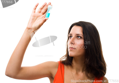 Image of Woman look on blue test tube and thinking