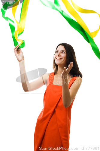Image of Woman in vivid color dress play with flying ribbon