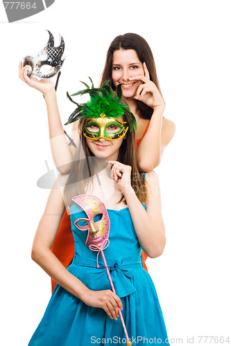 Image of Two positive young women with mask at masquerade party