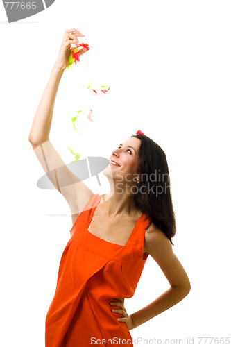 Image of Young woman in orange dress with flying