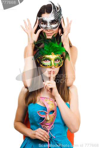 Image of Two young women in masks make hush sign