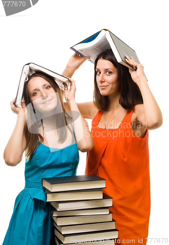 Image of Two young student woman play with books 