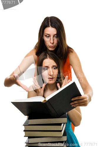 Image of wo shocked woman look into book