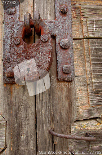 Image of Padlock And Handle On Wooden Gate