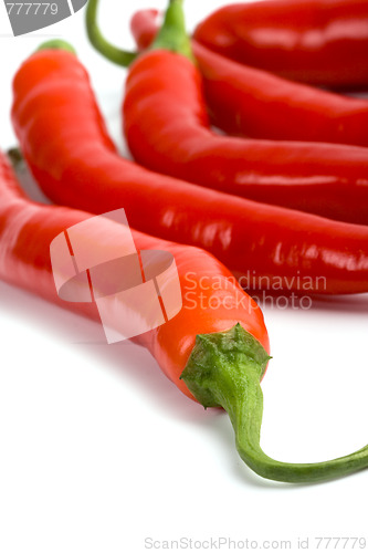 Image of five red chilli peppers