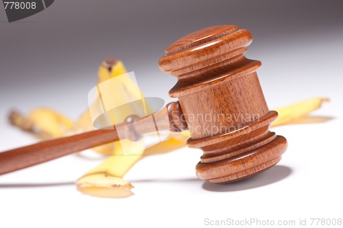 Image of Gavel and Banana Peel on Gradated Background