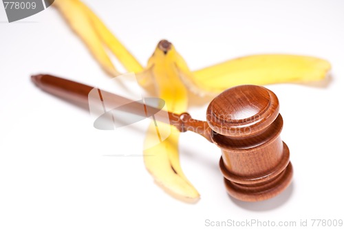 Image of Gavel and Banana Peel on Gradated Background