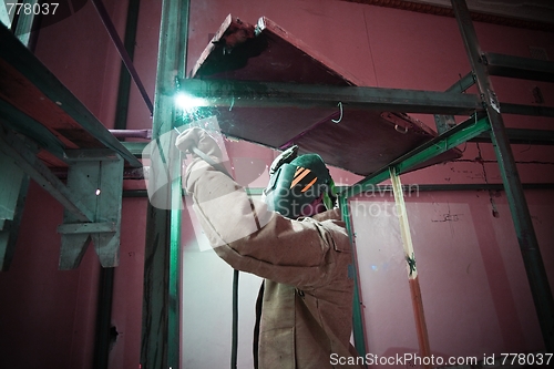 Image of Welder work with metal construction