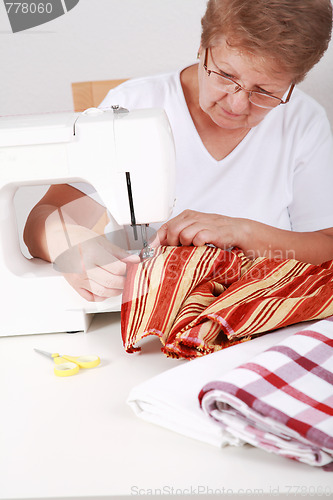 Image of Elderly woman sewing