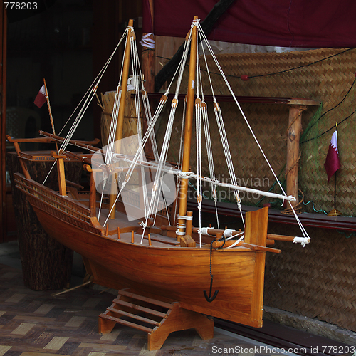 Image of Model dhow and Qatari flag