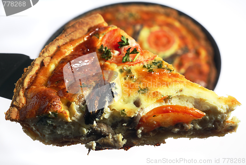 Image of Slice of quiche being lifted from a baking pan