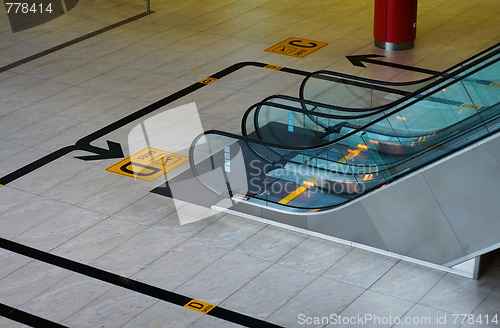 Image of Escalator and sign to departure gate in airport