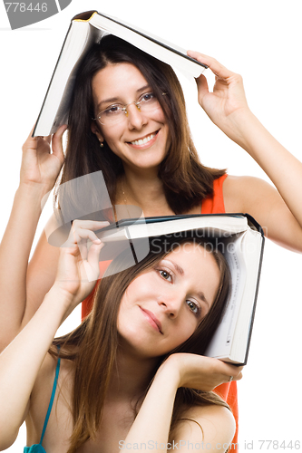 Image of Two happy women friends with books play and smile