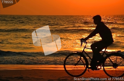 Image of Cycling At Sunset On The Beach