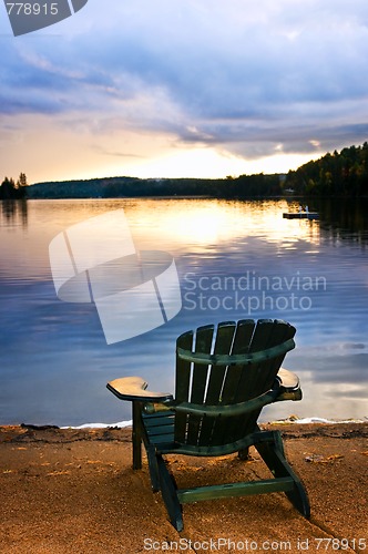 Image of Wooden chair at sunset on beach